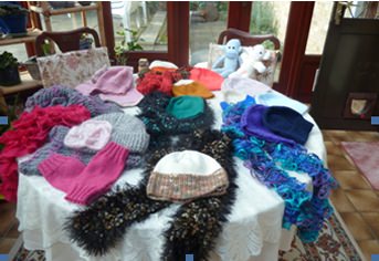 Some scarves and hats created by the 'Woollen Tops'